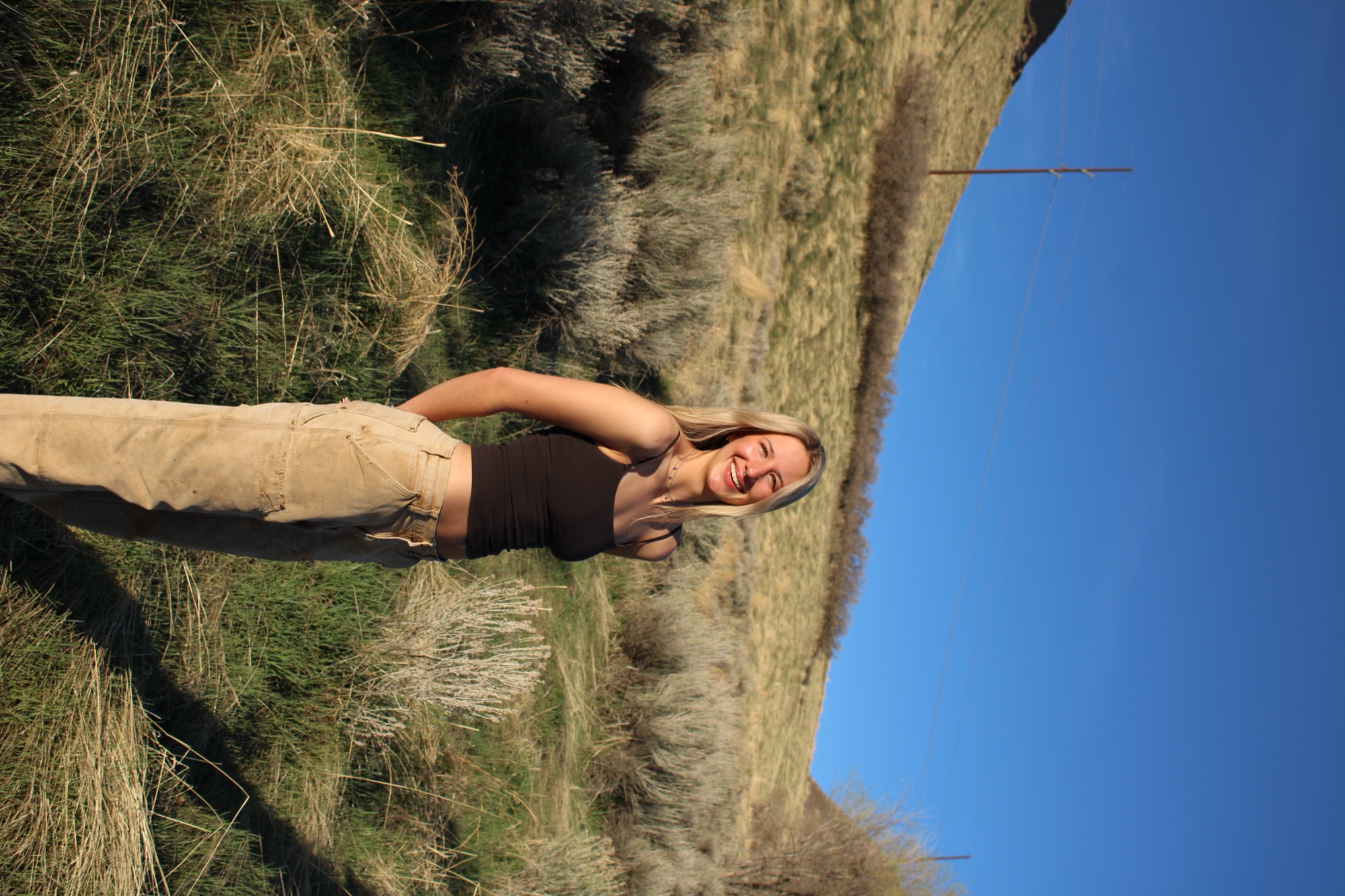 Senior portrait on grassy hillside